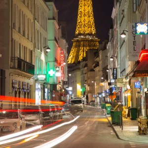 long exposure Eiffel Tower and colorful Paris street at night                             